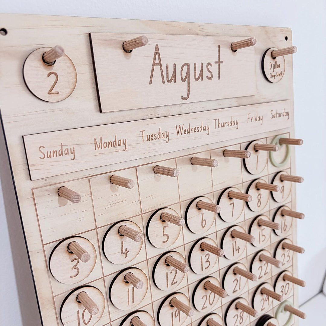 Montessori-inspired classroom calendar with wooden discs for days, months, seasons, weather incl. six Nyoongar seasons.