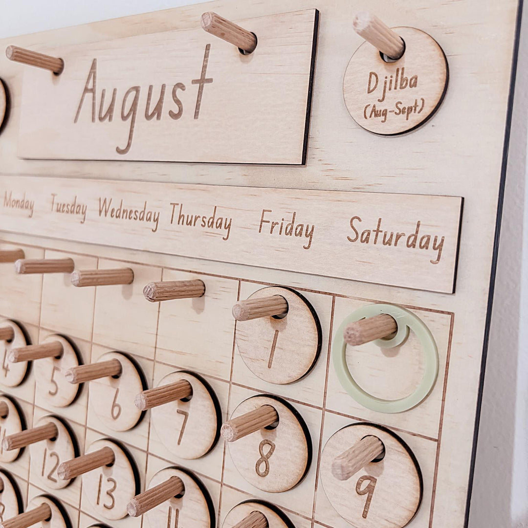 Montessori-inspired classroom calendar with wooden discs for days, months, seasons, weather incl. six Nyoongar seasons.