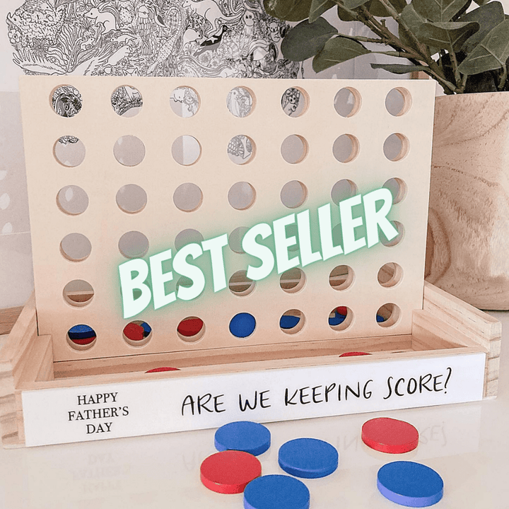 A personalised 4-in-a-row game with a wooden board, black and white acrylic plates, red and blue markers, and text personalization options. Perfect for Father&